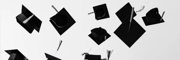 graduation hats flying in the air